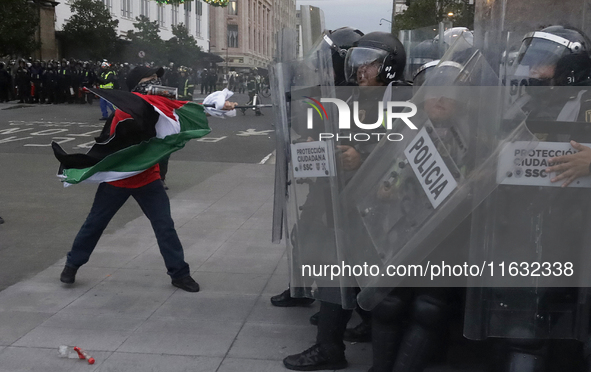 Members of the Anarchist Black Bloc clash with police during the march to mark the 56th anniversary of the Tlatelolco Massacre, which starts...