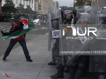 Members of the Anarchist Black Bloc clash with police during the march to mark the 56th anniversary of the Tlatelolco Massacre, which starts...