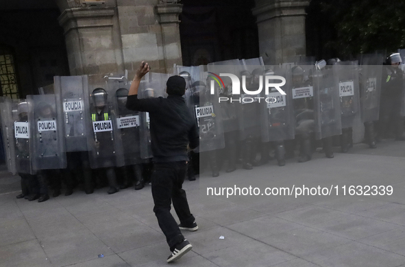 Members of the Anarchist Black Bloc clash with police during the march to mark the 56th anniversary of the Tlatelolco Massacre, which starts...