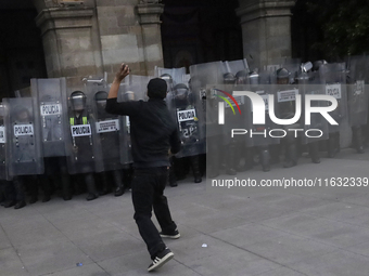 Members of the Anarchist Black Bloc clash with police during the march to mark the 56th anniversary of the Tlatelolco Massacre, which starts...