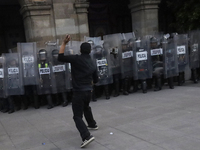 Members of the Anarchist Black Bloc clash with police during the march to mark the 56th anniversary of the Tlatelolco Massacre, which starts...