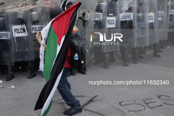 Members of the Anarchist Black Bloc clash with police during the march to mark the 56th anniversary of the Tlatelolco Massacre, which starts...