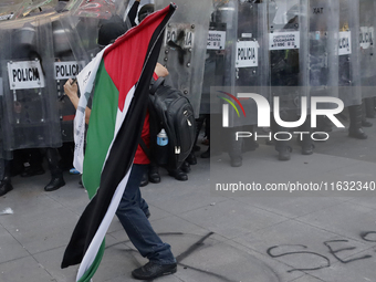 Members of the Anarchist Black Bloc clash with police during the march to mark the 56th anniversary of the Tlatelolco Massacre, which starts...