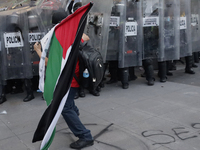 Members of the Anarchist Black Bloc clash with police during the march to mark the 56th anniversary of the Tlatelolco Massacre, which starts...