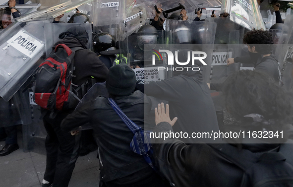 Members of the Anarchist Black Bloc clash with police during the march to mark the 56th anniversary of the Tlatelolco Massacre, which starts...