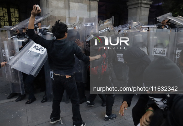 Members of the Anarchist Black Bloc clash with police during the march to mark the 56th anniversary of the Tlatelolco Massacre, which starts...