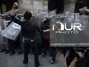 Members of the Anarchist Black Bloc clash with police during the march to mark the 56th anniversary of the Tlatelolco Massacre, which starts...