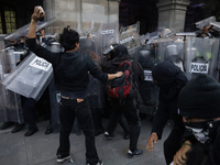 Members of the Anarchist Black Bloc clash with police during the march to mark the 56th anniversary of the Tlatelolco Massacre, which starts...