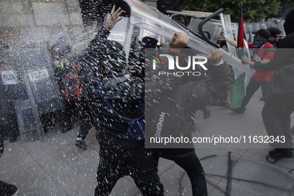 Members of the Anarchist Black Bloc clash with police during the march to mark the 56th anniversary of the Tlatelolco Massacre, which starts...