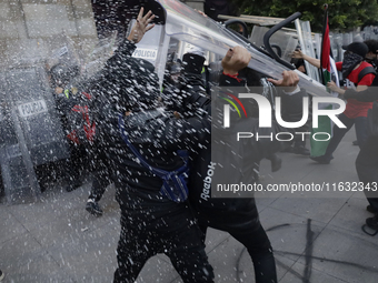 Members of the Anarchist Black Bloc clash with police during the march to mark the 56th anniversary of the Tlatelolco Massacre, which starts...