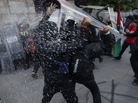 Members of the Anarchist Black Bloc clash with police during the march to mark the 56th anniversary of the Tlatelolco Massacre, which starts...