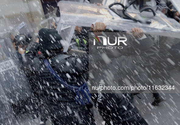 Members of the Anarchist Black Bloc clash with police during the march to mark the 56th anniversary of the Tlatelolco Massacre, which starts...