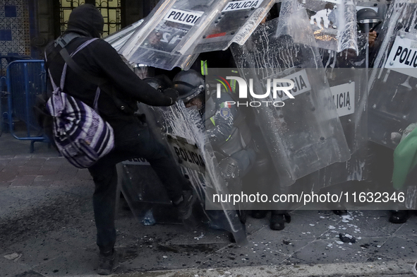 Members of the Anarchist Black Bloc clash with police during the march to mark the 56th anniversary of the Tlatelolco Massacre, which starts...