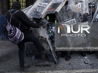 Members of the Anarchist Black Bloc clash with police during the march to mark the 56th anniversary of the Tlatelolco Massacre, which starts...