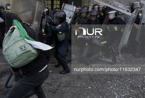 Members of the Anarchist Black Bloc clash with police during the march to mark the 56th anniversary of the Tlatelolco Massacre, which starts...