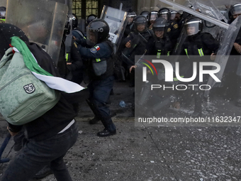 Members of the Anarchist Black Bloc clash with police during the march to mark the 56th anniversary of the Tlatelolco Massacre, which starts...