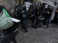 Members of the Anarchist Black Bloc clash with police during the march to mark the 56th anniversary of the Tlatelolco Massacre, which starts...