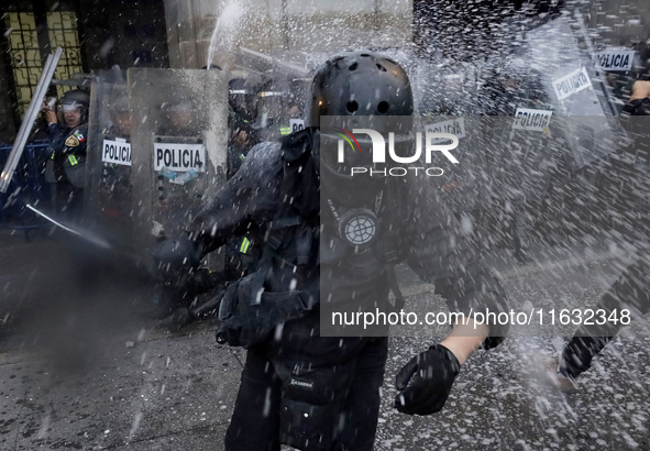 Members of the Anarchist Black Bloc clash with police during the march to mark the 56th anniversary of the Tlatelolco Massacre, which starts...