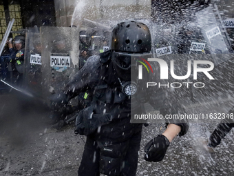 Members of the Anarchist Black Bloc clash with police during the march to mark the 56th anniversary of the Tlatelolco Massacre, which starts...