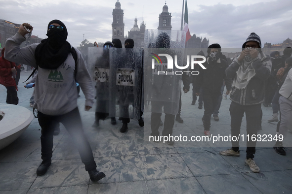 Members of the Anarchist Black Bloc clash with police during the march to mark the 56th anniversary of the Tlatelolco Massacre, which starts...