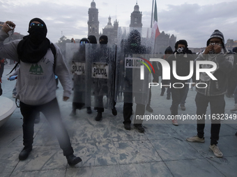 Members of the Anarchist Black Bloc clash with police during the march to mark the 56th anniversary of the Tlatelolco Massacre, which starts...