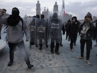 Members of the Anarchist Black Bloc clash with police during the march to mark the 56th anniversary of the Tlatelolco Massacre, which starts...