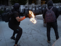 Members of the Anarchist Black Bloc throw Molotov cocktails at the police during the march to mark the 56th anniversary of the Tlatelolco Ma...