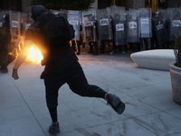 Members of the Anarchist Black Bloc throw Molotov cocktails at the police during the march to mark the 56th anniversary of the Tlatelolco Ma...