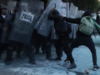 Members of the Anarchist Black Bloc clash with police during the march to mark the 56th anniversary of the Tlatelolco Massacre, which starts...