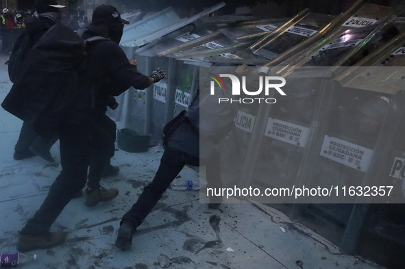 Members of the Anarchist Black Bloc clash with police during the march to mark the 56th anniversary of the Tlatelolco Massacre, which starts...