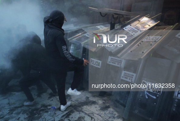 Members of the Anarchist Black Bloc clash with police during the march to mark the 56th anniversary of the Tlatelolco Massacre, which starts...