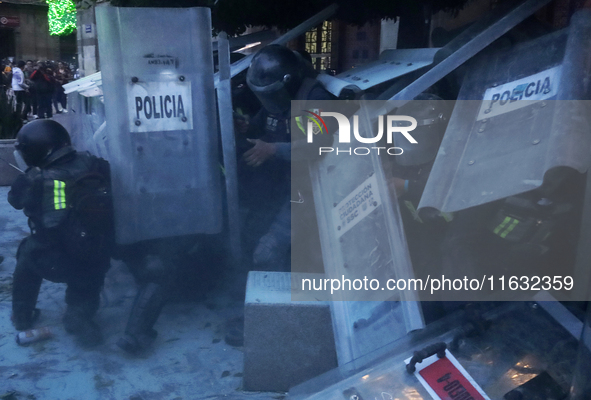 Members of the Anarchist Black Bloc clash with police during the march to mark the 56th anniversary of the Tlatelolco Massacre, which starts...