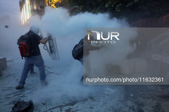 Members of the Anarchist Black Bloc clash with police during the march to mark the 56th anniversary of the Tlatelolco Massacre, which starts...