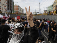 Members of the Anarchist Black Bloc paint graffiti during the march to mark the 56th anniversary of the Tlatelolco Massacre that occurred on...