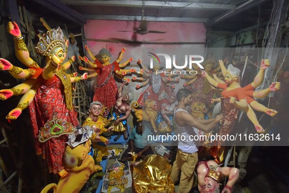 An artisan decorates the idol of the Hindu Goddess Durga ahead of the Durga Puja festival in Nagaon District, Assam, India, on October 3, 20...