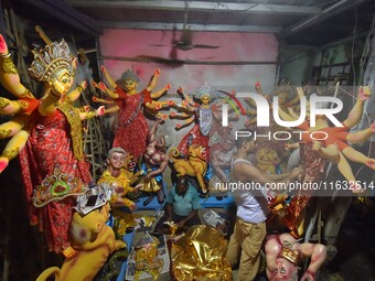 An artisan decorates the idol of the Hindu Goddess Durga ahead of the Durga Puja festival in Nagaon District, Assam, India, on October 3, 20...