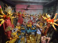 An artisan decorates the idol of the Hindu Goddess Durga ahead of the Durga Puja festival in Nagaon District, Assam, India, on October 3, 20...