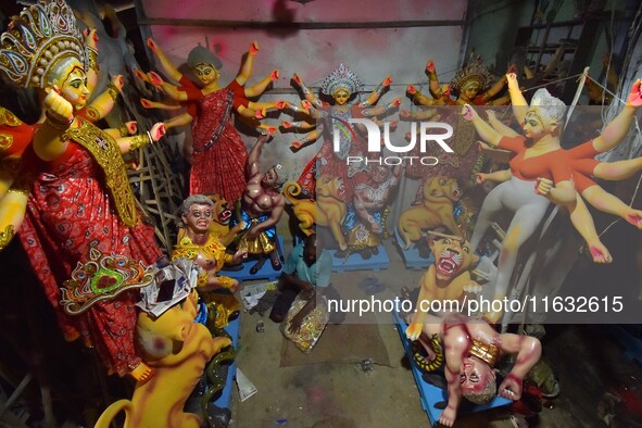 An artisan decorates the idol of the Hindu Goddess Durga ahead of the Durga Puja festival in Nagaon District, Assam, India, on October 3, 20...