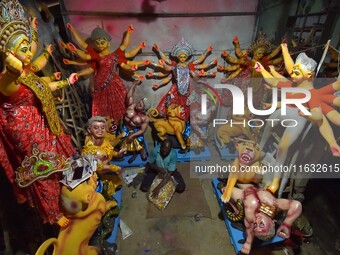 An artisan decorates the idol of the Hindu Goddess Durga ahead of the Durga Puja festival in Nagaon District, Assam, India, on October 3, 20...