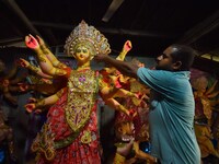 An artisan decorates the idol of the Hindu Goddess Durga ahead of the Durga Puja festival in Nagaon District, Assam, India, on October 3, 20...