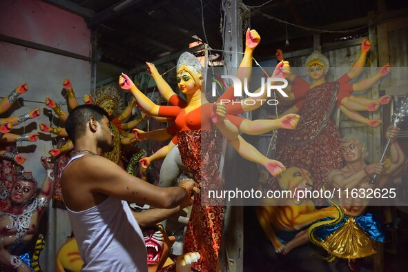 An artisan decorates the idol of the Hindu Goddess Durga ahead of the Durga Puja festival in Nagaon District, Assam, India, on October 3, 20...