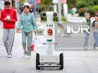 A 5G ''robot police'' patrols a business district in Zhoushan, China, on October 3, 2024. (