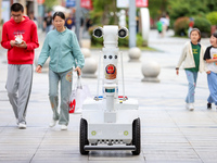 A 5G ''robot police'' patrols a business district in Zhoushan, China, on October 3, 2024. (