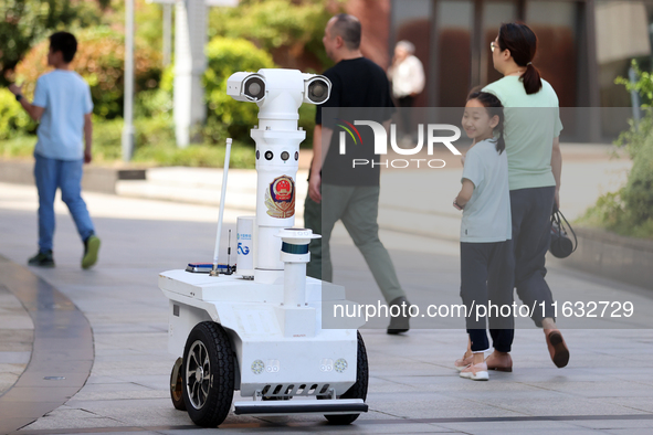 A 5G ''robot police'' patrols a business district in Zhoushan, China, on October 3, 2024. 