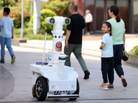 A 5G ''robot police'' patrols a business district in Zhoushan, China, on October 3, 2024. (