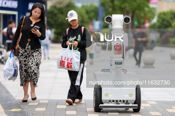 A 5G ''robot police'' patrols a business district in Zhoushan, China, on October 3, 2024. 