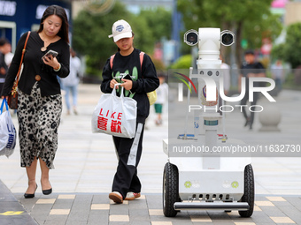 A 5G ''robot police'' patrols a business district in Zhoushan, China, on October 3, 2024. (