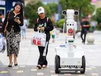 A 5G ''robot police'' patrols a business district in Zhoushan, China, on October 3, 2024. (