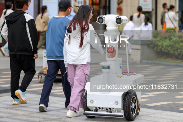 A 5G ''robot police'' patrols a business district in Zhoushan, China, on October 3, 2024. 