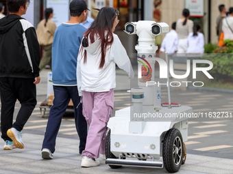 A 5G ''robot police'' patrols a business district in Zhoushan, China, on October 3, 2024. (